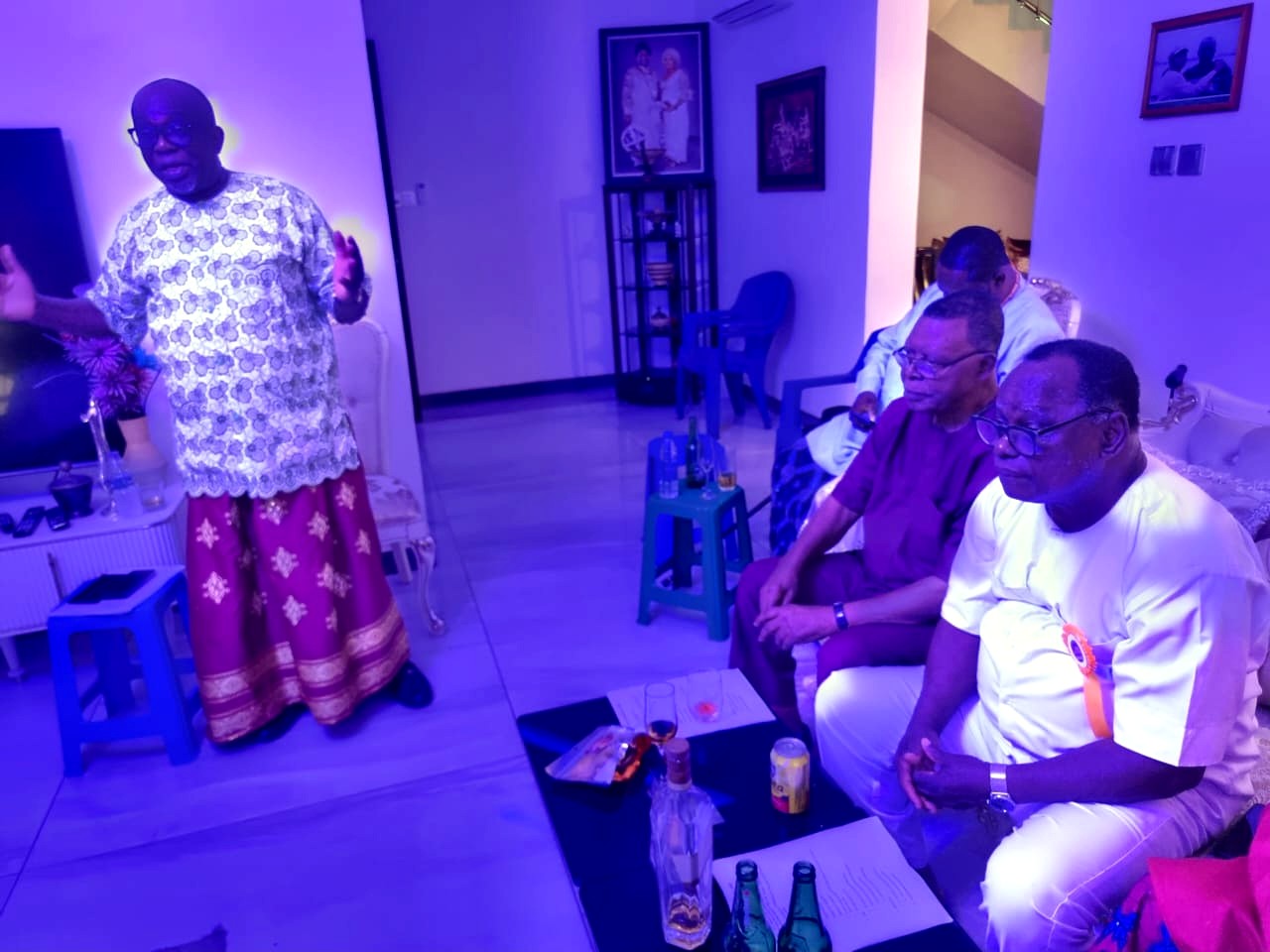 A member standing to address a roomful of Urhobo Social Club Lagos members at a club meeting